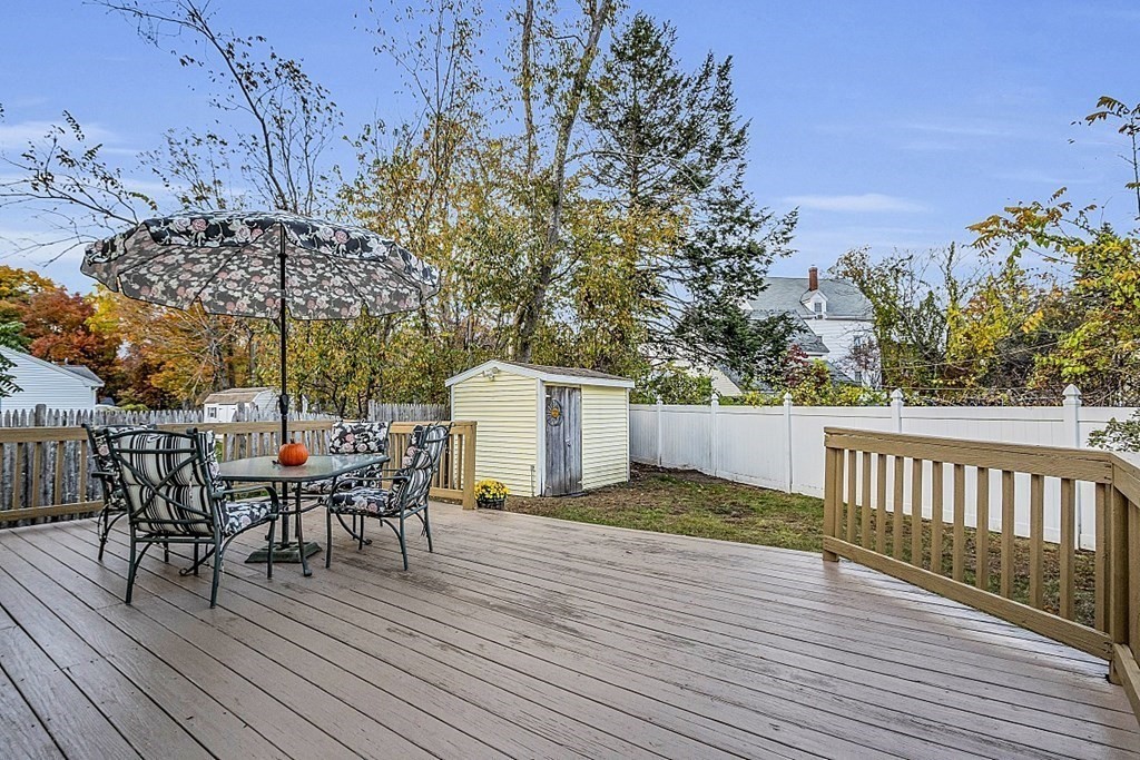 271 Broadway Haverhill, MA 01832 - Photo 24 of 26 a view of a roof deck with table and chairs and wooden floor