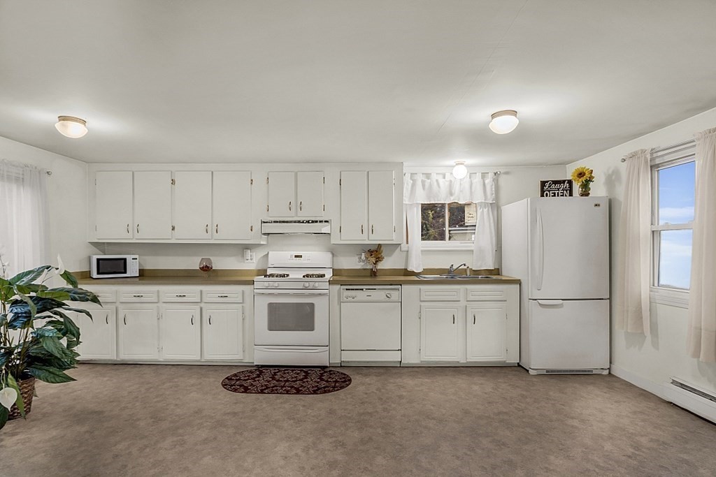 271 Broadway Haverhill, MA 01832 - Photo 8 of 26 a kitchen with granite countertop cabinets and white appliances