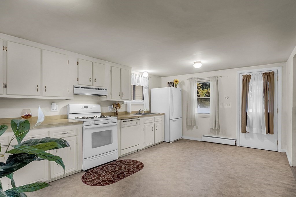 271 Broadway Haverhill, MA 01832 - Photo 9 of 26 a kitchen with stainless steel appliances granite countertop a refrigerator sink and white cabinets