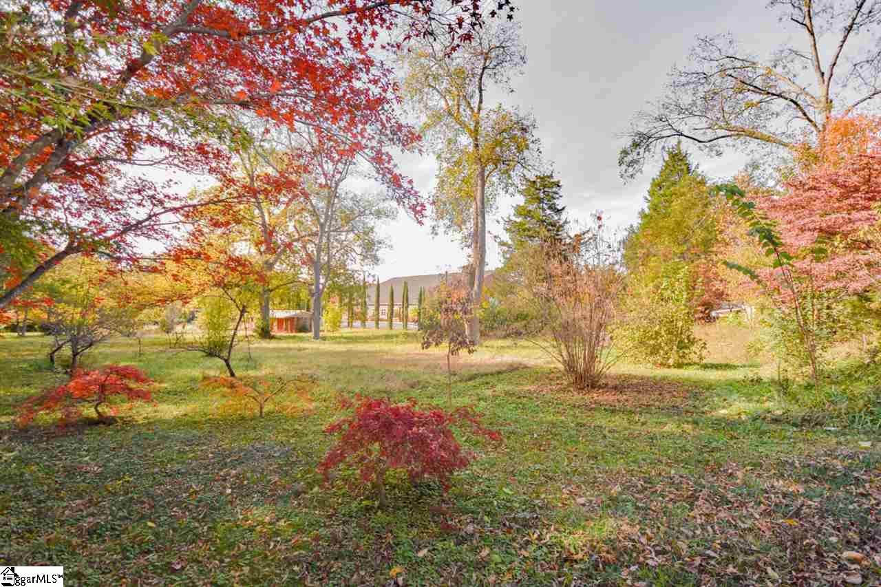 301 North Main Street Fountain Inn, SC 29644 - Photo 29 of 34 Very Private back yard, great for relaxing. Just look at those beautiful fall colors. There is something in bloom almost year round with all the foliage and trees on this 1.6 acres.