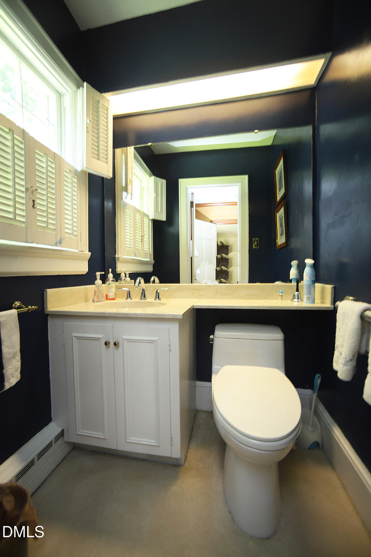 2601 York Road Raleigh, NC 27608 - Photo 10 of 24 a bathroom with a toilet sink and mirror