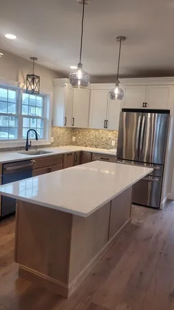 a view of kitchen with stainless steel appliances granite countertop stove top oven and cabinets