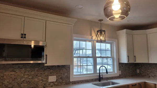 a view of a livingroom with furniture and staircase