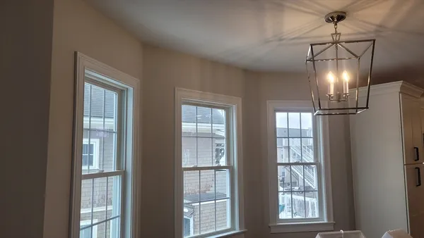a room with lots of windows and chandelier