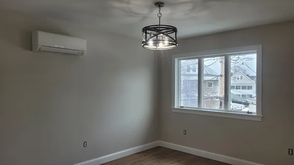 a view of a room with a window and ceiling fan