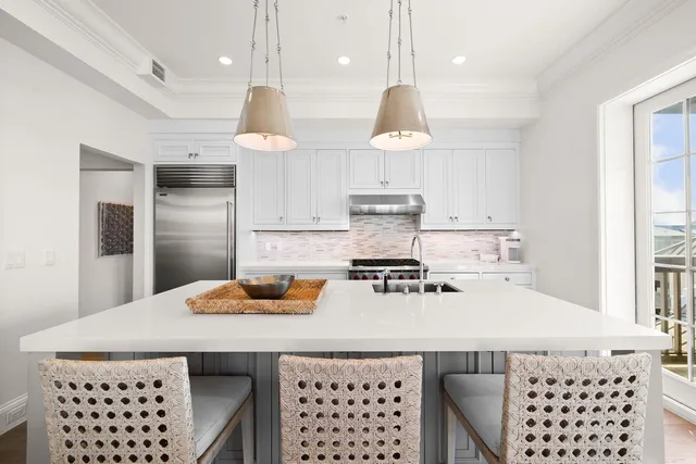 a view of a dining room and livingroom with furniture wooden floor a chandelier