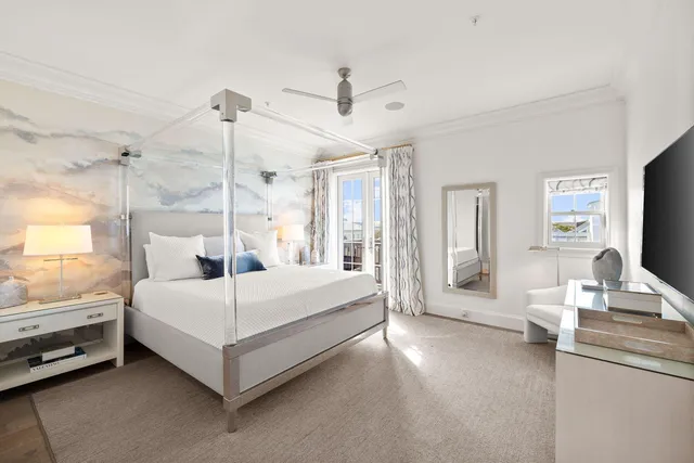 a bedroom with a bed lamp and a window