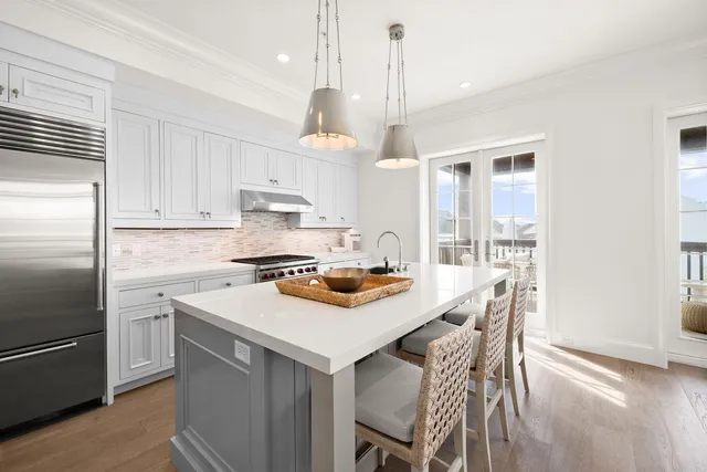 a kitchen with a sink a stove and chairs