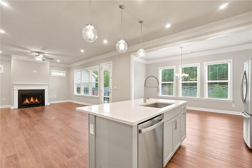 2070 Abbey Road Roswell, GA 30076 - Photo 7 of 65 a open kitchen with a sink and a fireplace