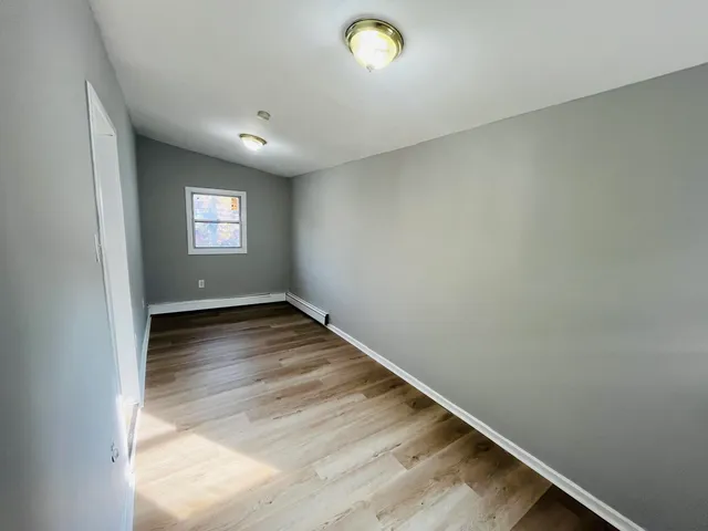 a view of hallway with wooden floor