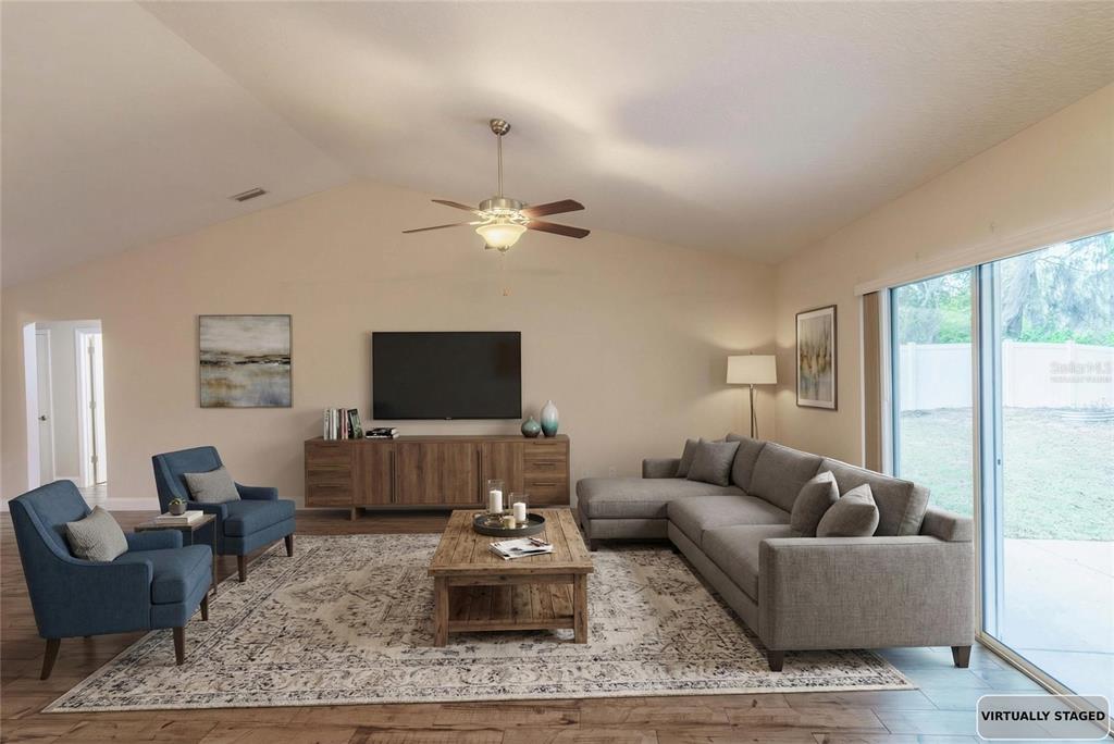 5273 Southwest 96th Place Ocala, FL 34476 - Photo 11 of 55 a living room with furniture and a flat screen tv