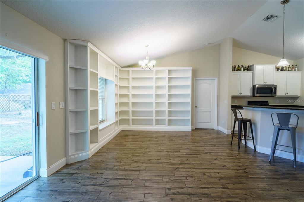 5273 Southwest 96th Place Ocala, FL 34476 - Photo 12 of 55 a view of a room with furniture and wooden floor
