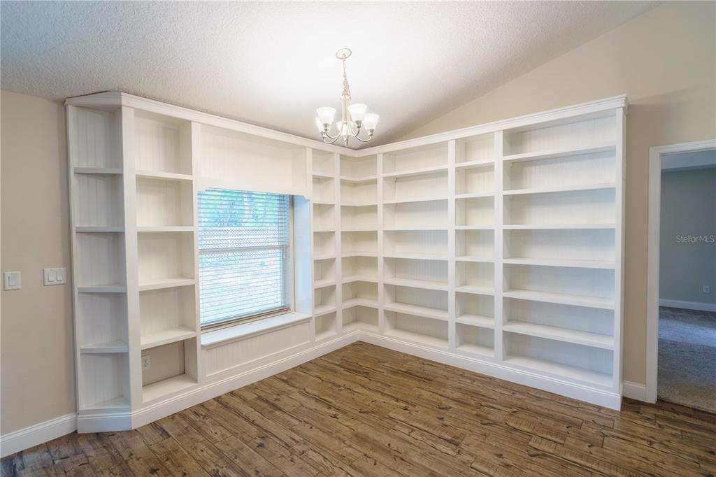 5273 Southwest 96th Place Ocala, FL 34476 - Photo 15 of 55 a view of an empty room with a window and wooden floor