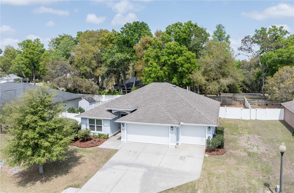 5273 Southwest 96th Place Ocala, FL 34476 - Photo 2 of 55 an aerial view of a house with yard and trees in the background