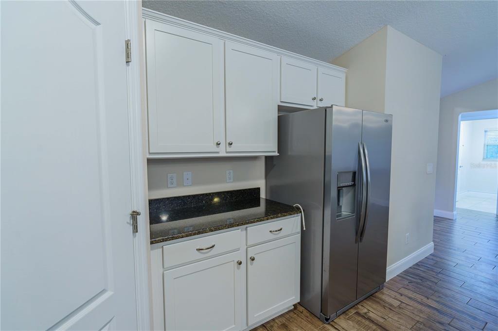 5273 Southwest 96th Place Ocala, FL 34476 - Photo 22 of 55 a kitchen with stainless steel appliances white cabinets and a granite counter tops