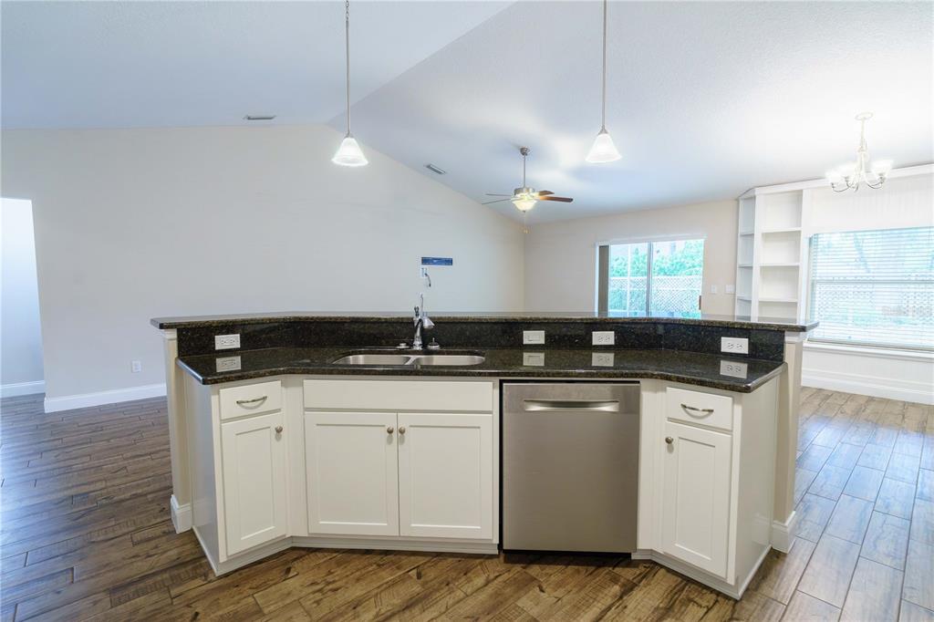 5273 Southwest 96th Place Ocala, FL 34476 - Photo 24 of 55 a kitchen with a sink a counter space appliances and cabinets