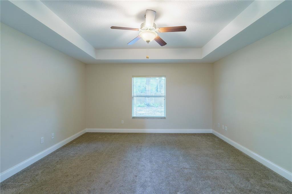 5273 Southwest 96th Place Ocala, FL 34476 - Photo 25 of 55 an empty room with a window and a ceiling fan