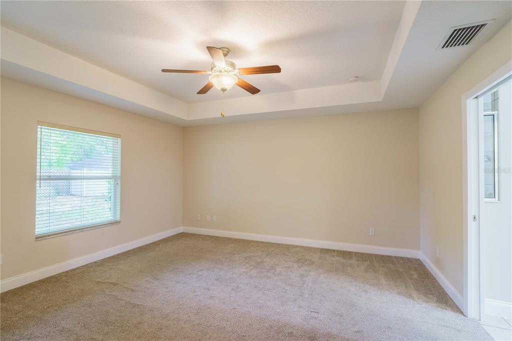 5273 Southwest 96th Place Ocala, FL 34476 - Photo 27 of 55 an empty room with windows and fan