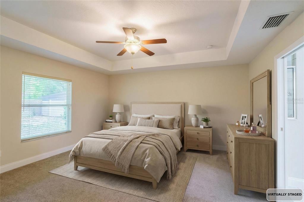 5273 Southwest 96th Place Ocala, FL 34476 - Photo 28 of 55 a bedroom with a bed and a chandelier