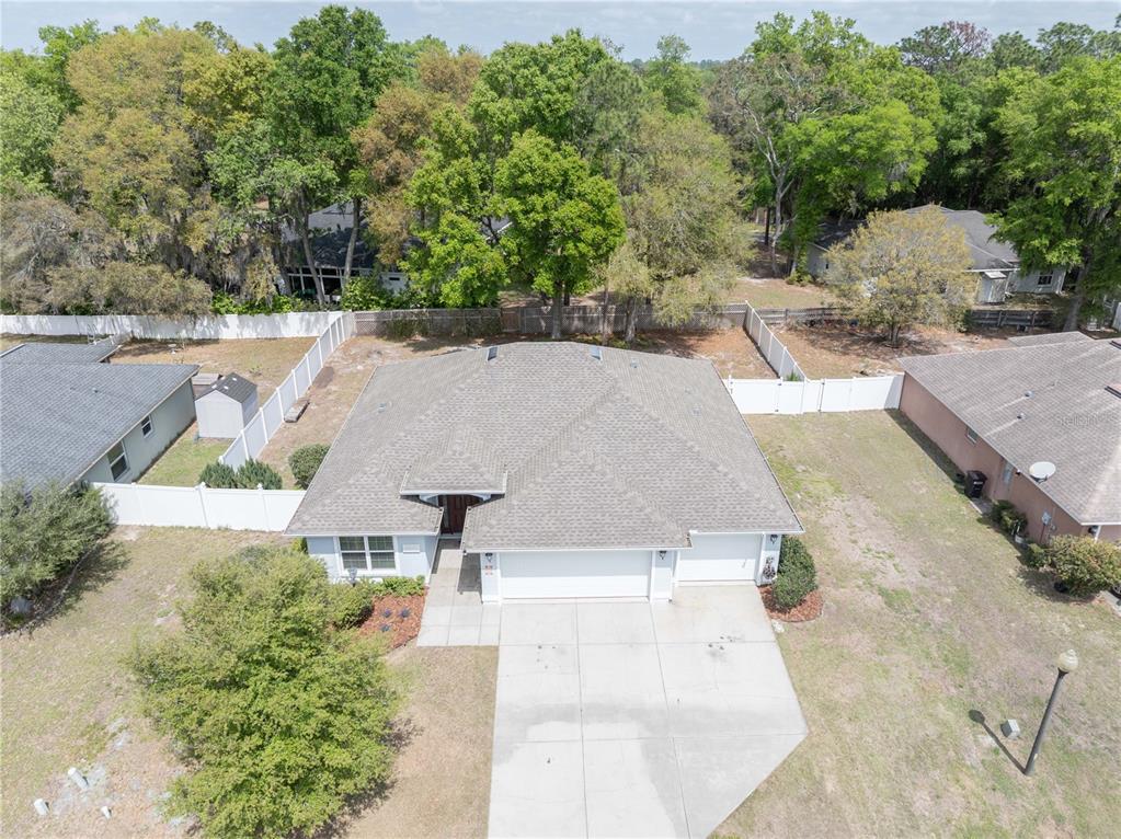 5273 Southwest 96th Place Ocala, FL 34476 - Photo 3 of 55 an aerial view of a house with a yard and trees