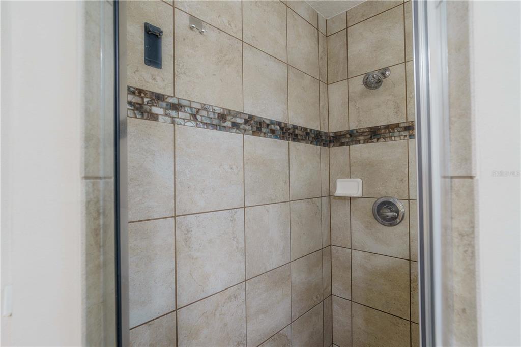 5273 Southwest 96th Place Ocala, FL 34476 - Photo 31 of 55 a bathroom with a glass shower door