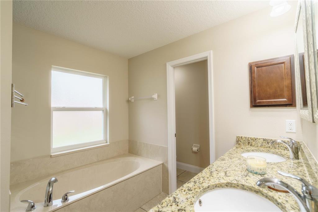 5273 Southwest 96th Place Ocala, FL 34476 - Photo 33 of 55 a bedroom with a bed and a window