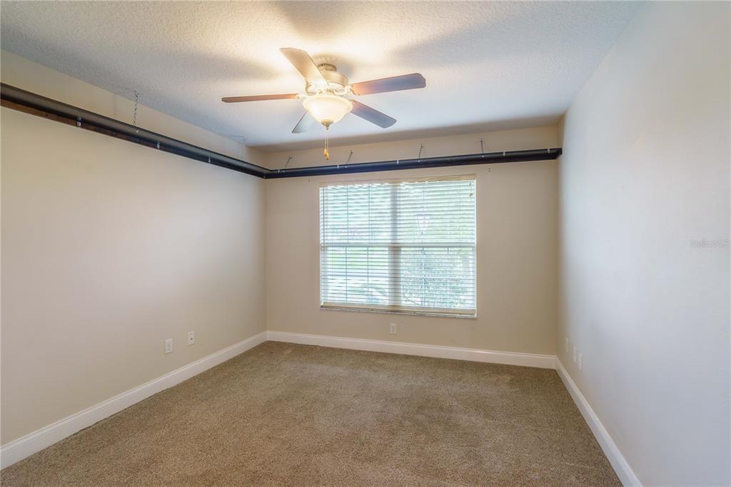 5273 Southwest 96th Place Ocala, FL 34476 - Photo 41 of 55 an empty room with a window and a fan
