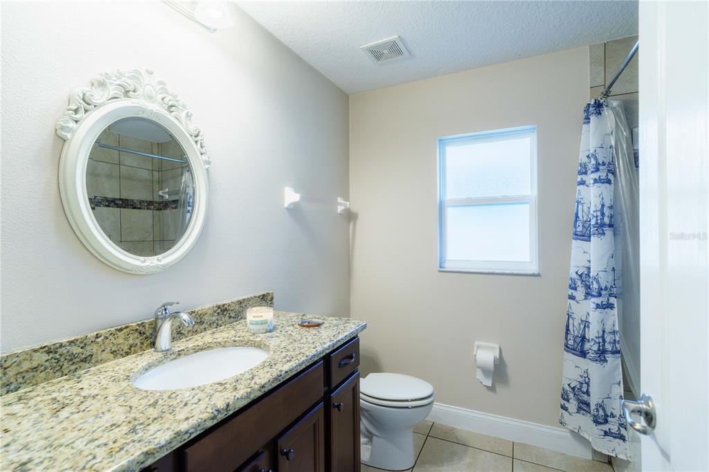 5273 Southwest 96th Place Ocala, FL 34476 - Photo 46 of 55 a bathroom with a granite countertop sink and a mirror