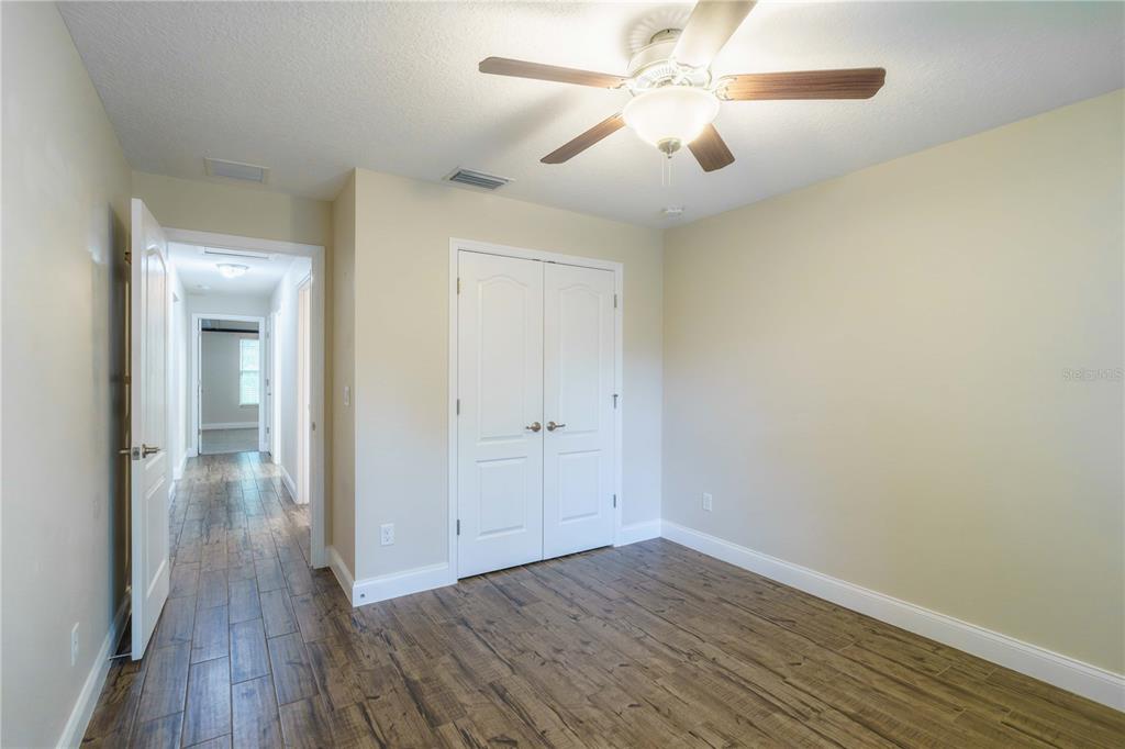 5273 Southwest 96th Place Ocala, FL 34476 - Photo 49 of 55 wooden floor in an empty room with a window