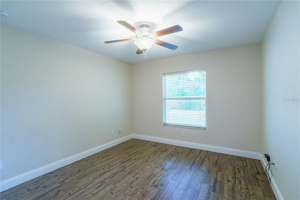 5273 Southwest 96th Place Ocala, FL 34476 - Photo 50 of 55 an empty room with wooden floor and windows