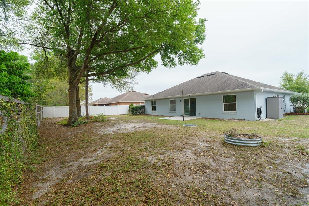 5273 Southwest 96th Place Ocala, FL 34476 - Photo 54 of 55 a front view of a house with a yard