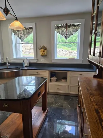 a kitchen with a sink and a large window