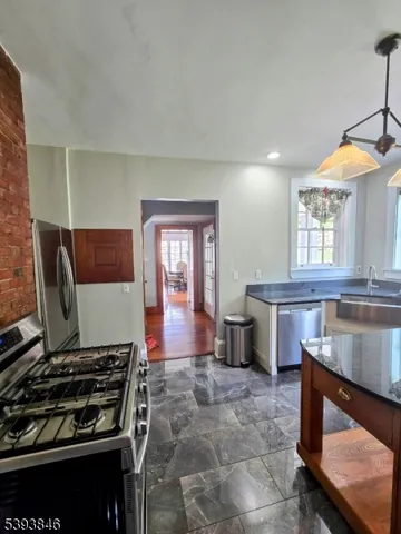a kitchen with sink stove and cabinets