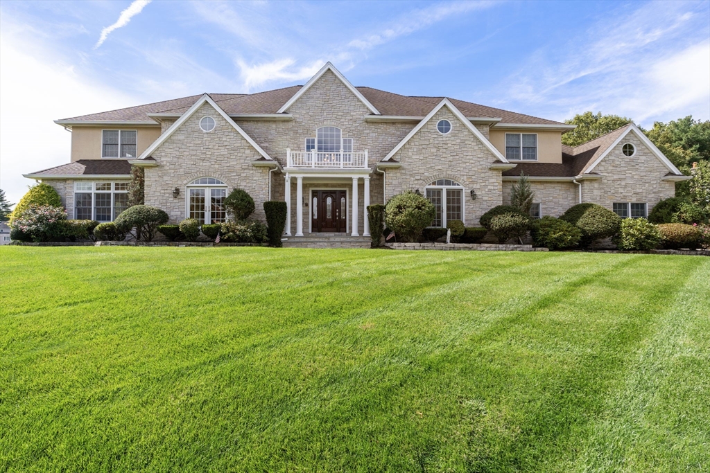 a front view of a house with a yard and garage