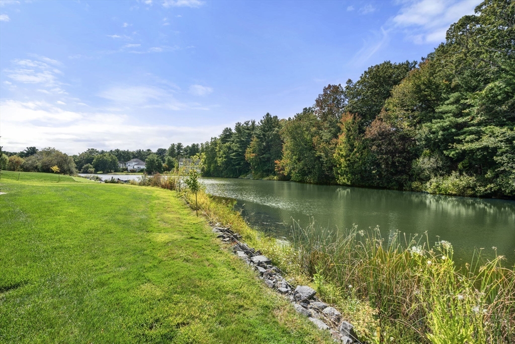19 Cherokee Road Canton, MA 02021 - Photo 32 of 42 a view of a lake with a big yard