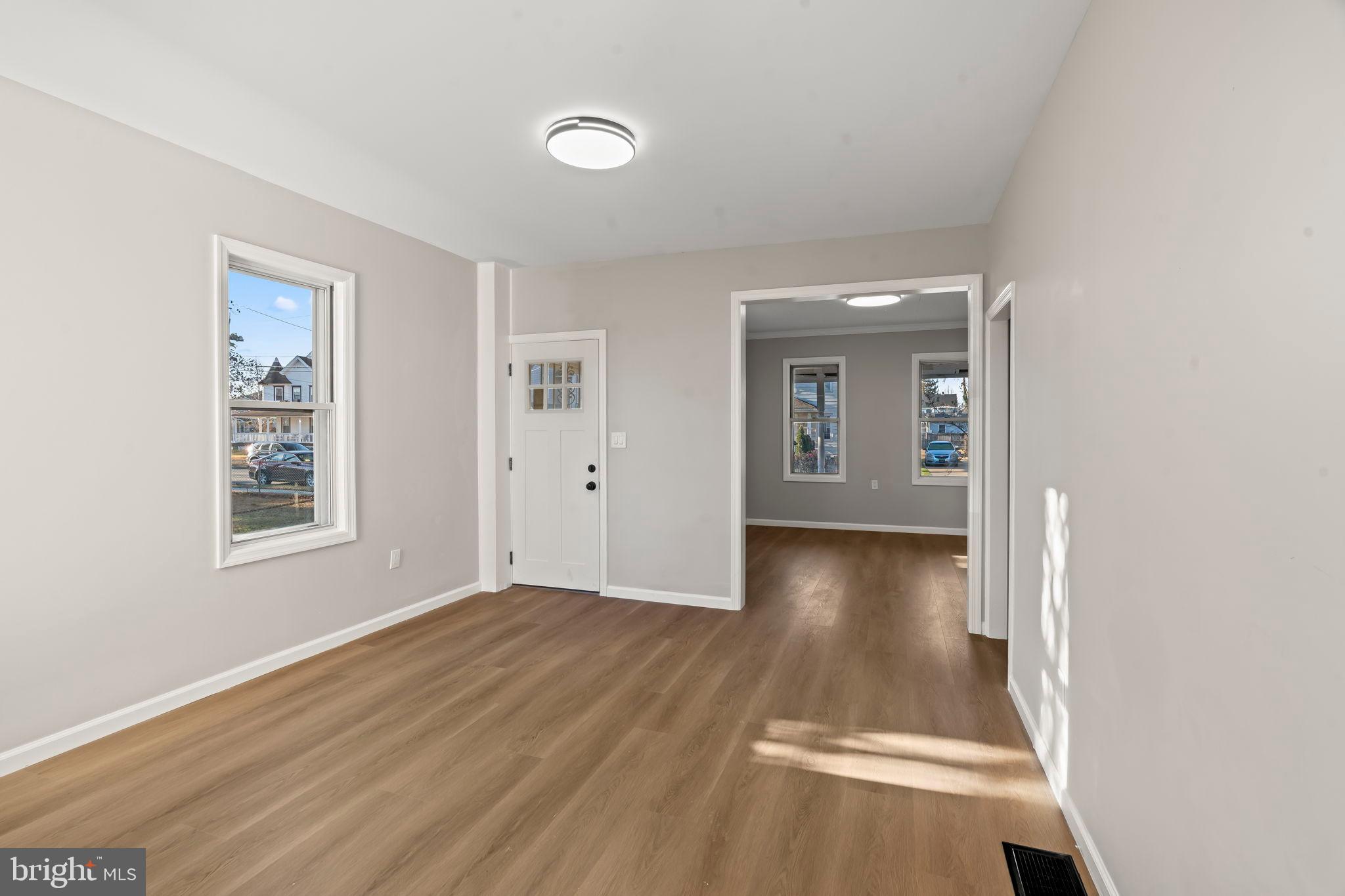606 Spruce Street Delanco, NJ 08075 - Photo 11 of 29 an empty room with wooden floor and windows