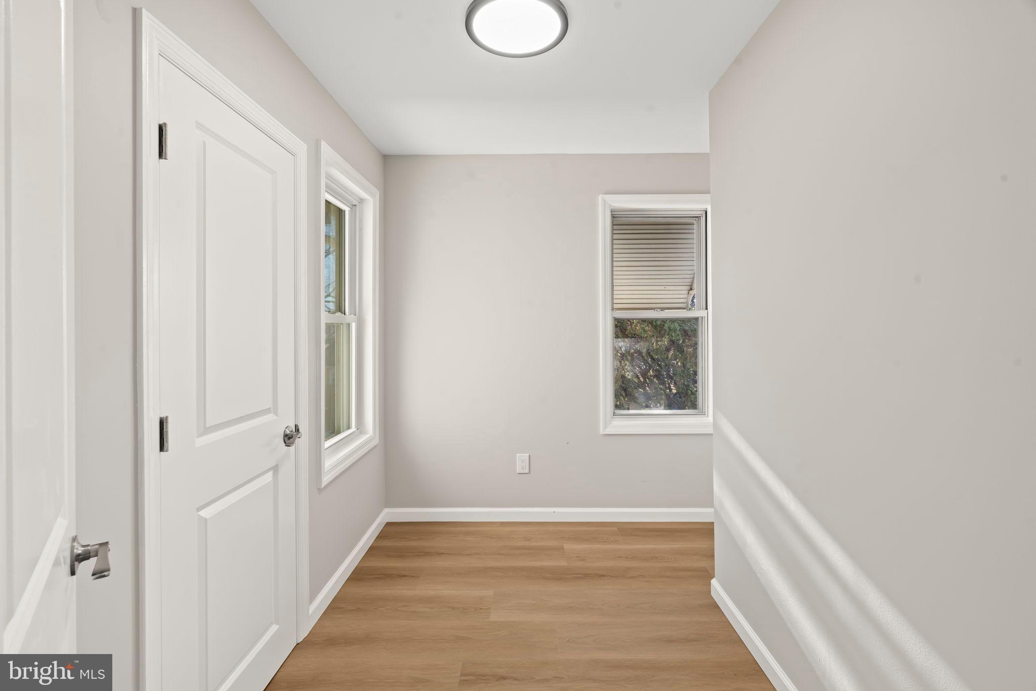 606 Spruce Street Delanco, NJ 08075 - Photo 18 of 29 a view of an empty room with wooden floor and a window
