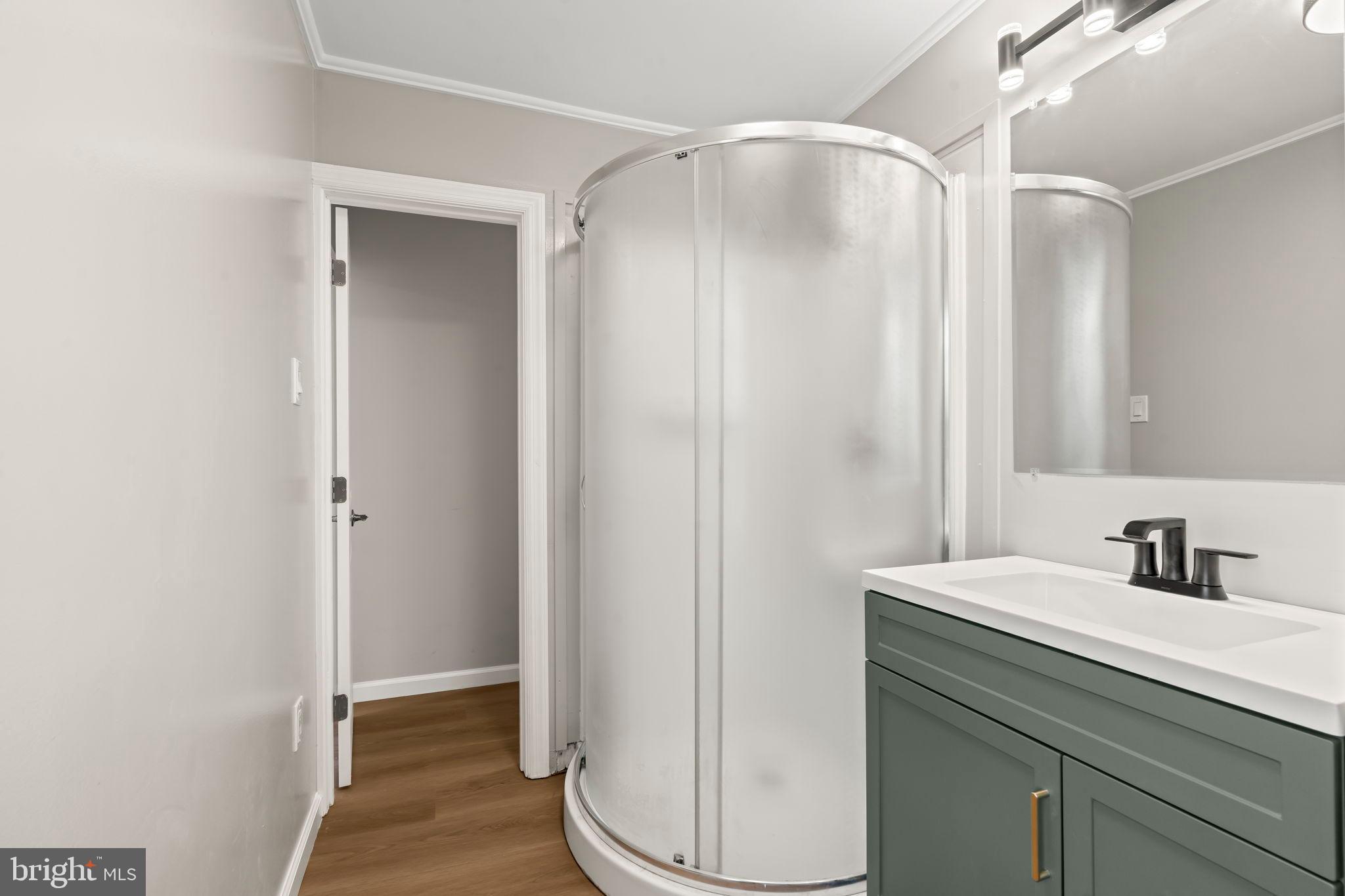 606 Spruce Street Delanco, NJ 08075 - Photo 23 of 29 a bathroom with a sink and a mirror