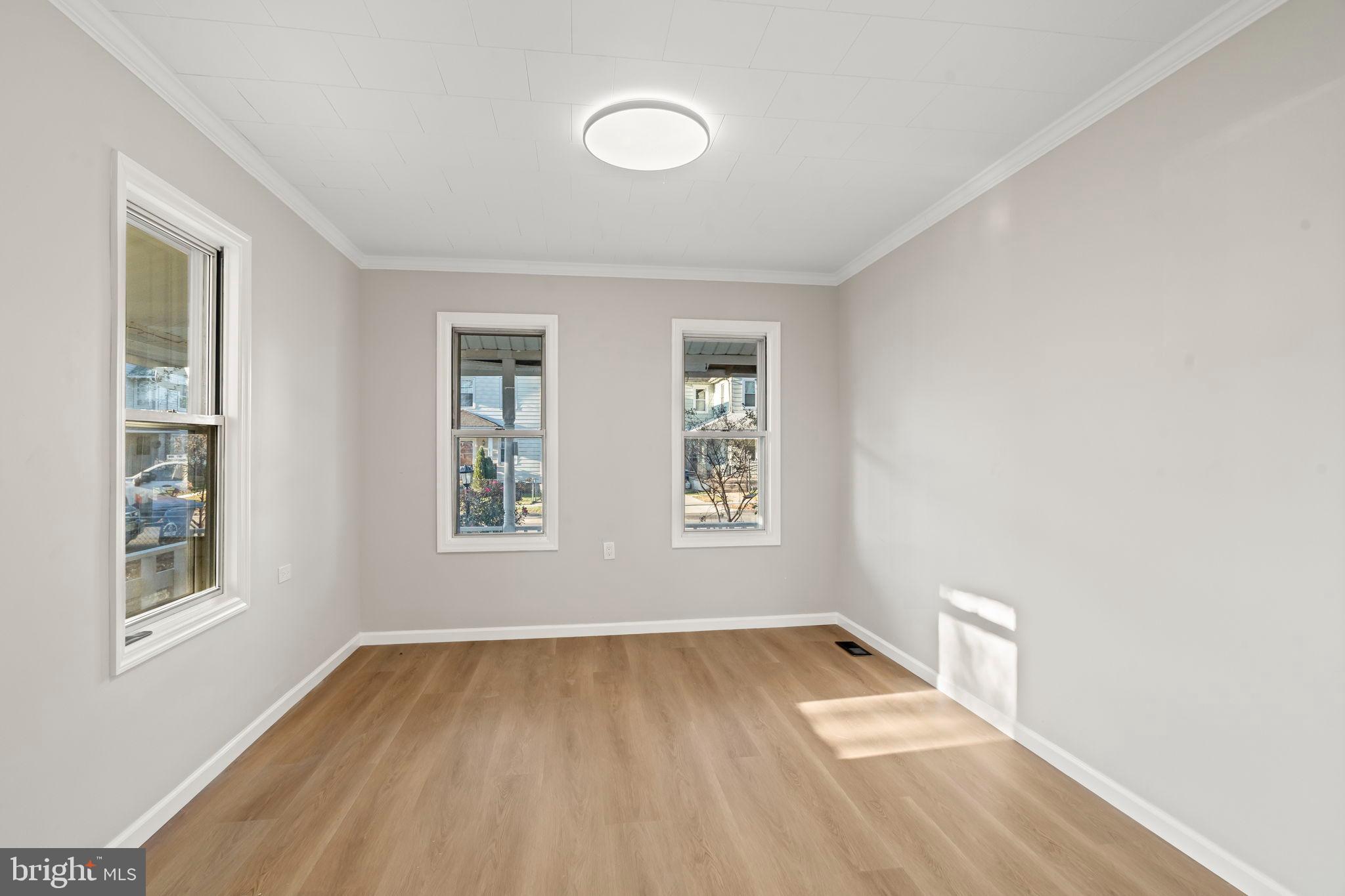 606 Spruce Street Delanco, NJ 08075 - Photo 5 of 29 an empty room with wooden floor and windows