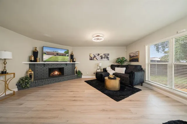 a living room with furniture a flat screen tv and a fireplace