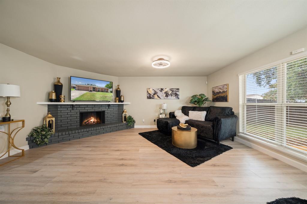 622 Roaming Rd Drive Allen, TX 75002 - Photo 13 of 27 a living room with furniture a flat screen tv and a fireplace