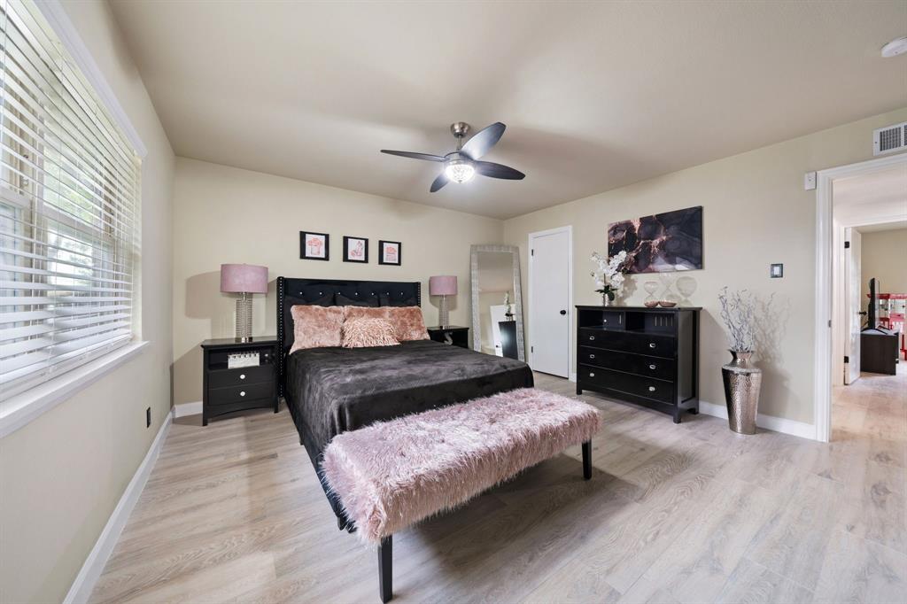 622 Roaming Rd Drive Allen, TX 75002 - Photo 16 of 27 a bedroom with a bed and a chandelier