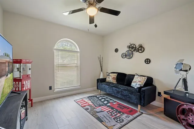a bedroom with furniture and a wooden floor