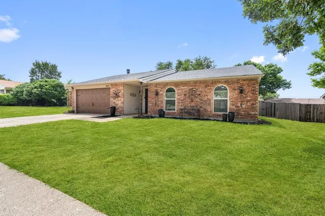 a front view of house with yard and green space