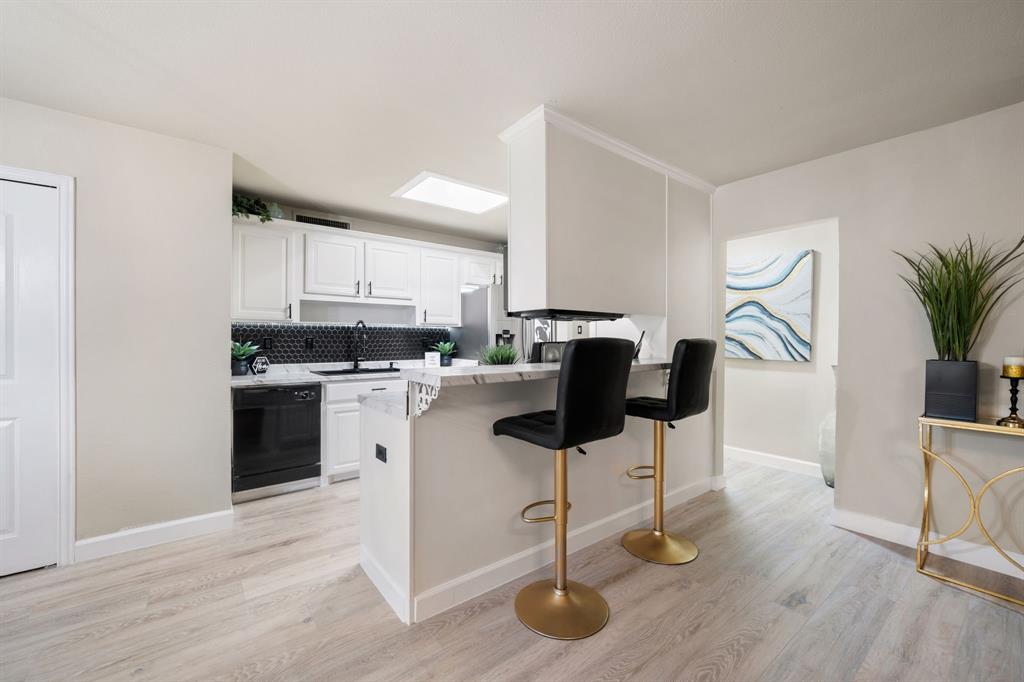 622 Roaming Rd Drive Allen, TX 75002 - Photo 9 of 27 a kitchen with stainless steel appliances kitchen island granite countertop a stove a sink and a white cabinets