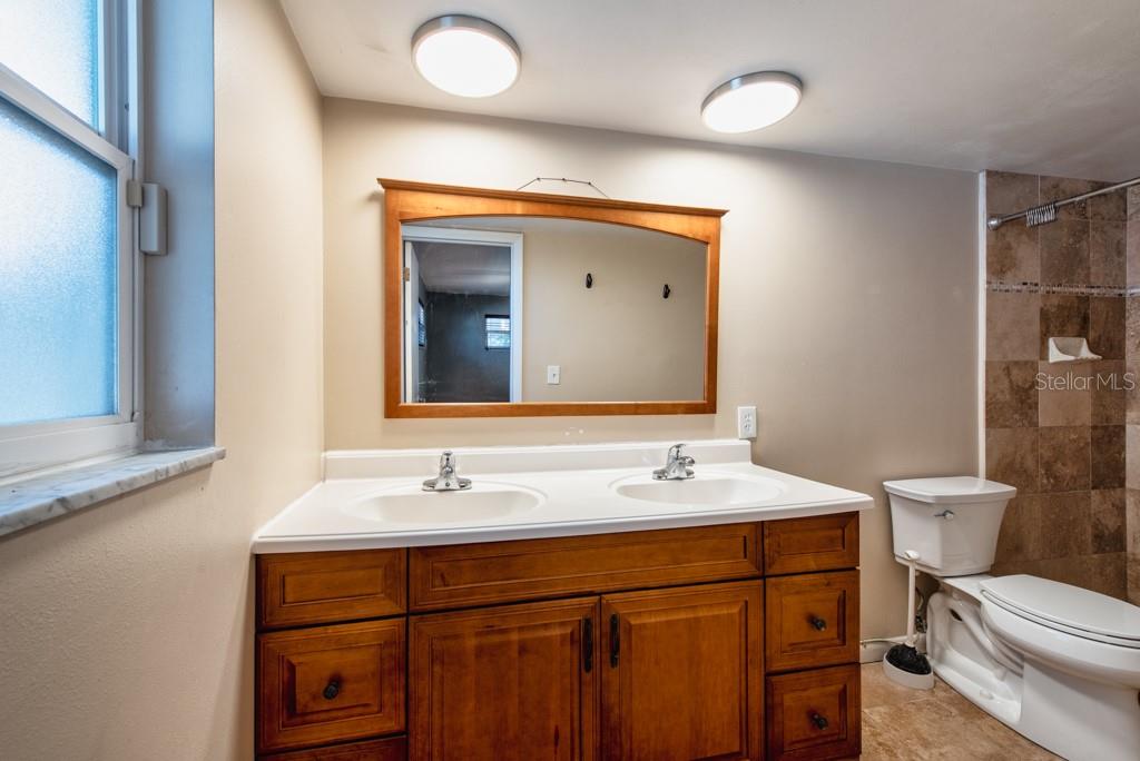 1877 Dawn Drive Clearwater, FL 33763 - Photo 14 of 36 a bathroom with a sink and a mirror