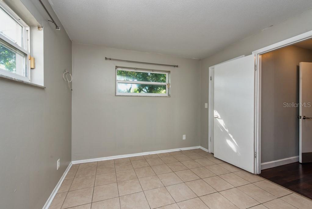 1877 Dawn Drive Clearwater, FL 33763 - Photo 19 of 36 an empty room with windows and closet