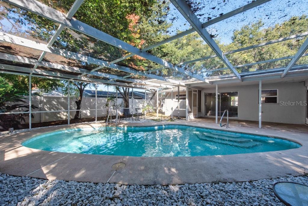 1877 Dawn Drive Clearwater, FL 33763 - Photo 25 of 36 a view of a swimming pool with a patio