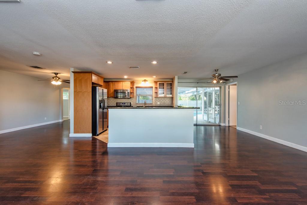 1877 Dawn Drive Clearwater, FL 33763 - Photo 4 of 36 a view of a kitchen with a refrigerator and wooden floor