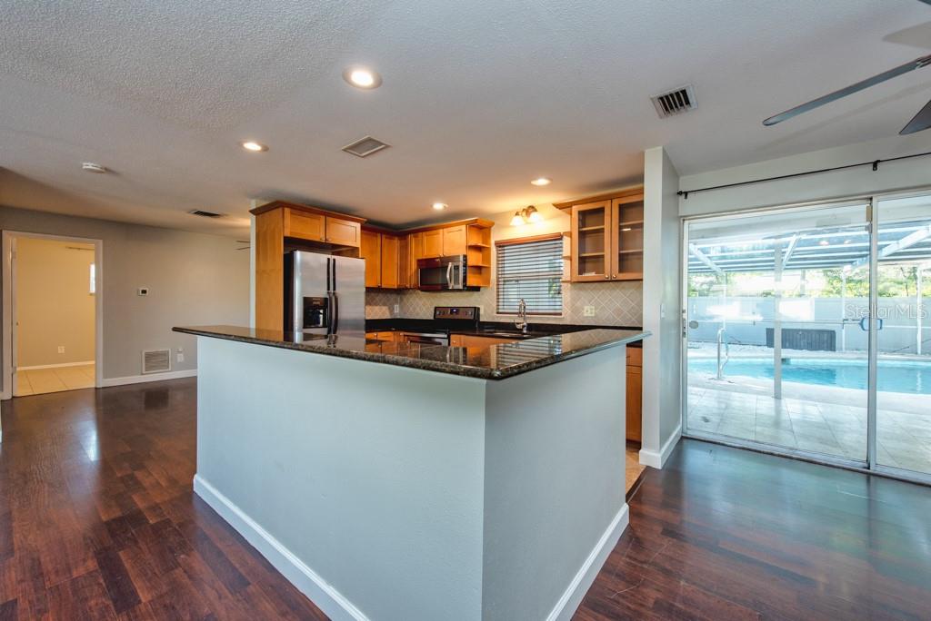 1877 Dawn Drive Clearwater, FL 33763 - Photo 7 of 36 a kitchen with stainless steel appliances granite countertop a refrigerator a sink and a stove